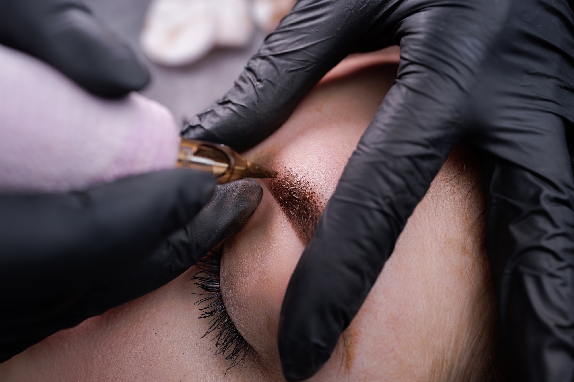 Macro photo of eyebrows with applied permanent makeup in pixel technique. PMU Procedure