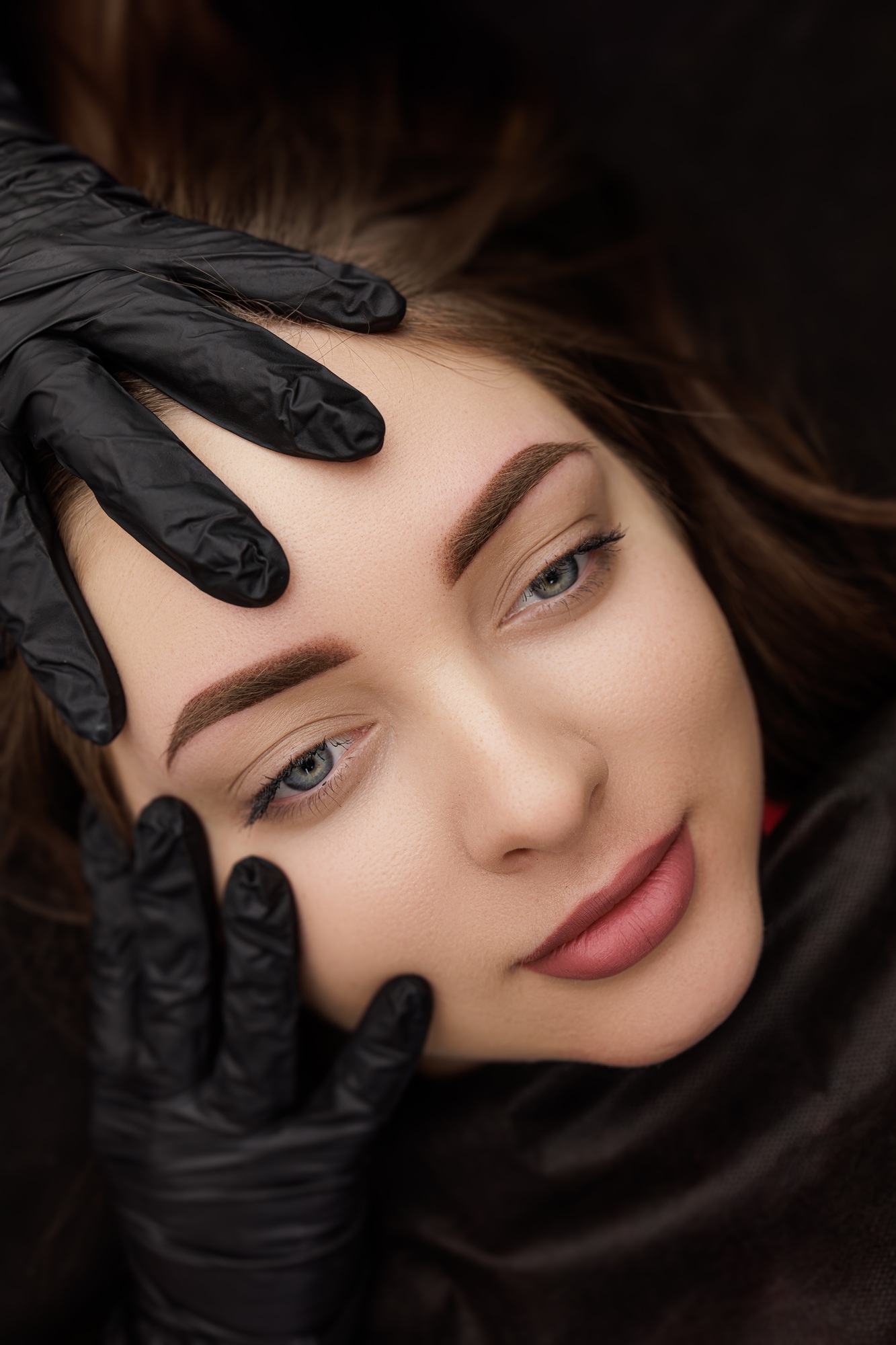 Model posing after correction of permanent eyebrow makeup completed work.